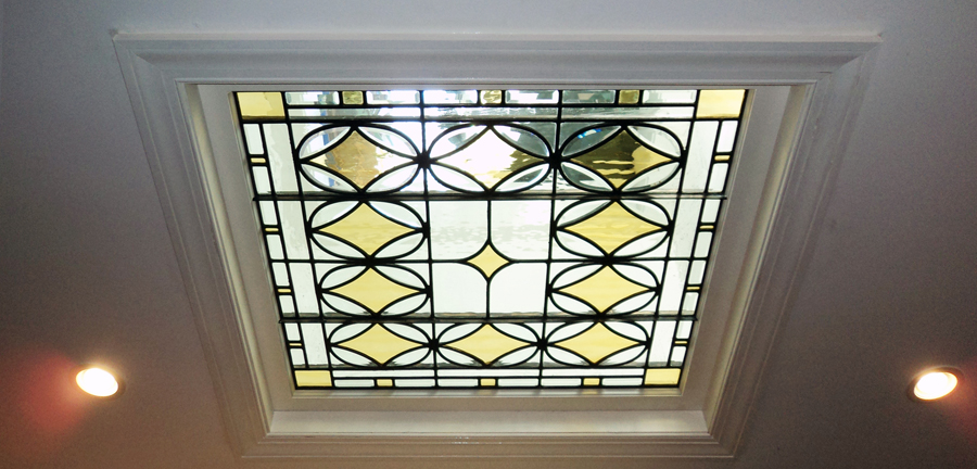 A stained glass skylight whose light colors and beautiful patterns make for a great light effect