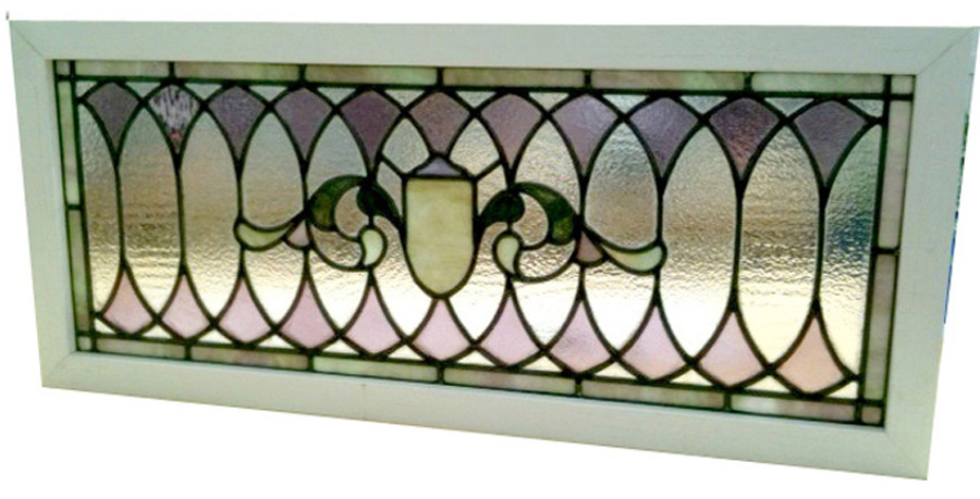A stained glass paneled transom with a lovely combination of purples and greens
